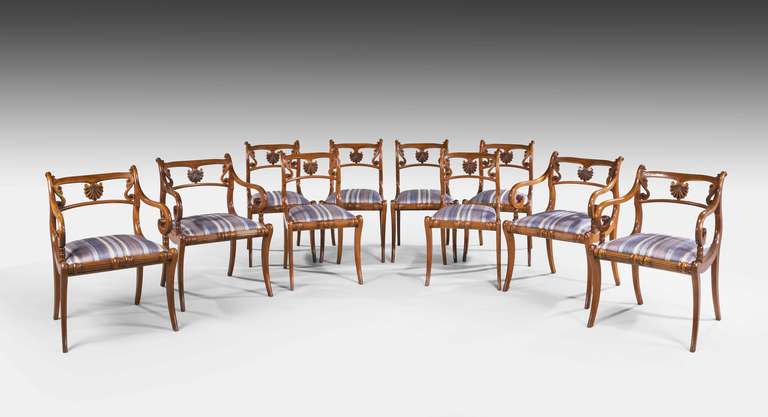 A quite exceptional set of ten (six sides and four arms) Regency period sabre leg chairs with delicately carved backs with unusual applied ebony highlights. Excellent overall quality.