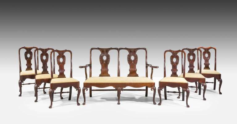 Fine 19th century Irish suite with finely shaped backs and well executed carving of garlands and leaves, finely carved and elaborate cabriole supports, swan neck arms to the sofa. Sold as a suite or sold separately as a sofa and six side chairs.