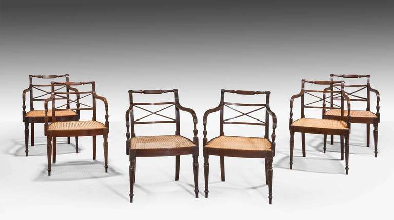 A good set of six George III period mahogany Elbow chairs, the top rail, the arm supports finely executed with reeded decoration, the 'X' backs with boxwood and satinwood line inlay, bow fronted front and side rails on finely tapering supports.