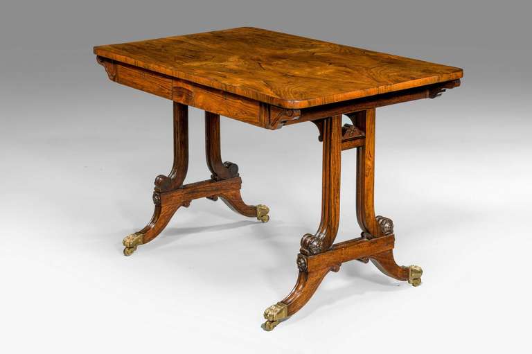 A Regency period Centre Standing Table on well-turned end supports, the freeze incorporating two drawers. Swept feet terminating in brass shoes and castors.
