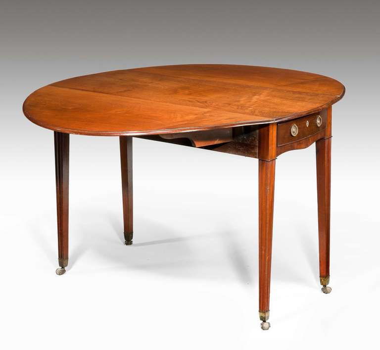 An oval late 18th century mahogany drop-leaf table on fine tapering supports and incorporating a single drawer.

RR.