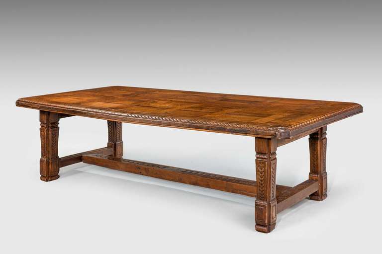 An unusual oak refectory table, the top with transverse block construction, a rope twist upper edge on square supports with well carved stretcher.