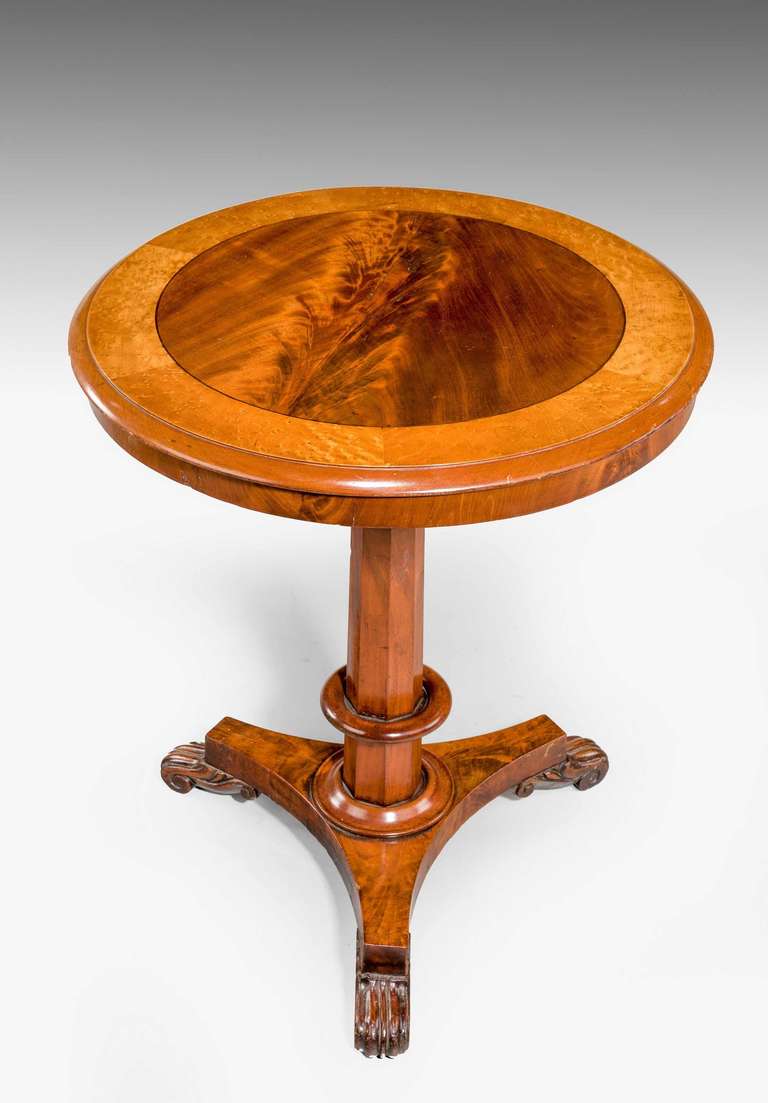 Regency period mahogany centre table of very small proportions, highly flamed veneers to the circular panel to the top within a cross banded edge, octagonal shaped support and terminating platform on three scrolled feet.

RR.