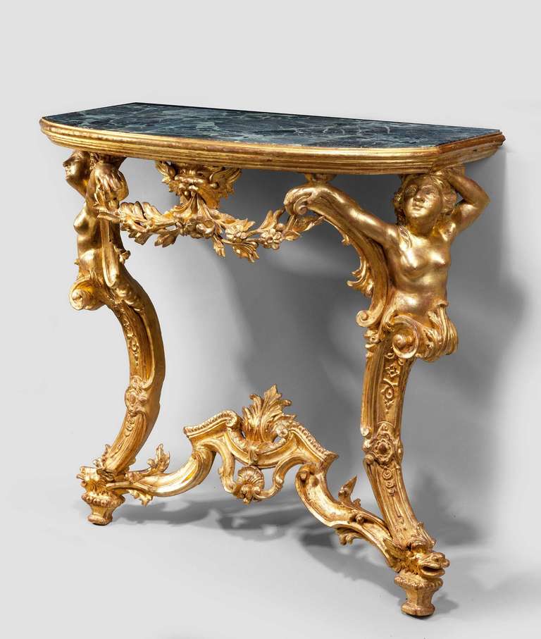 An important pair of 18th century giltwood pier tables of Rococo form, probably made in Rome, Italy. The supports of two putti holding swags and garlands, the beautifully carved bottom stretchers flowing to a central stylized leaf, with an unusual