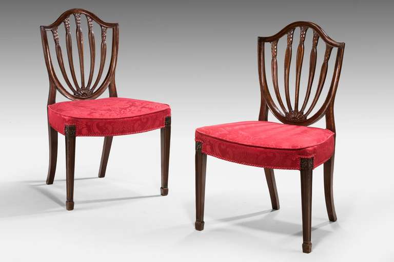 A pair of George III mahogany Hepplewhite chairs, the heart shaped backs with well carved uprights.

RR.