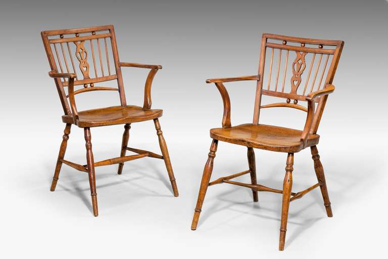 A good pair of 18th century yew tree Thames Valley Windsor chairs of unusually fine lines.

The Windsor chair is established as one of the great classics of English country furniture. They were made by village craftsmen to traditional designs in