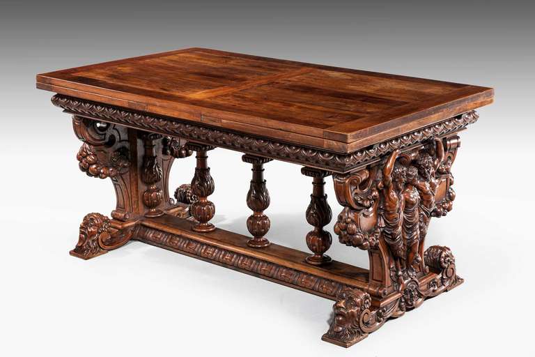 An exceptionally well carved walnut draw-leaf table, the ends vigorously carved with figures, scrolls and masks, Italian.

RR.