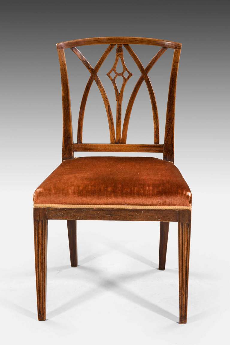 Set of six early 19th century elm dining chairs with Gothic inspired backs.
