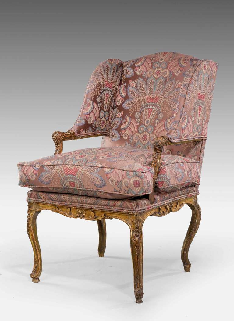 A late 19th century, French gilt wood Fauteuil, well carved frame with foliage and scroll work, the original gilding now tired.

A fauteuil is a style of open-arm chair with a primarily exposed wooden frame originating in France in the early 18th