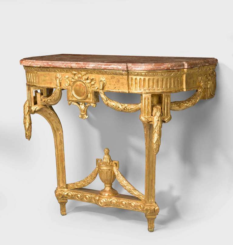 A Louis XVI neoclassical pier table of small dimensions, the two front supports, reeded, joined by a central urn, swags and scrolls.

RR.