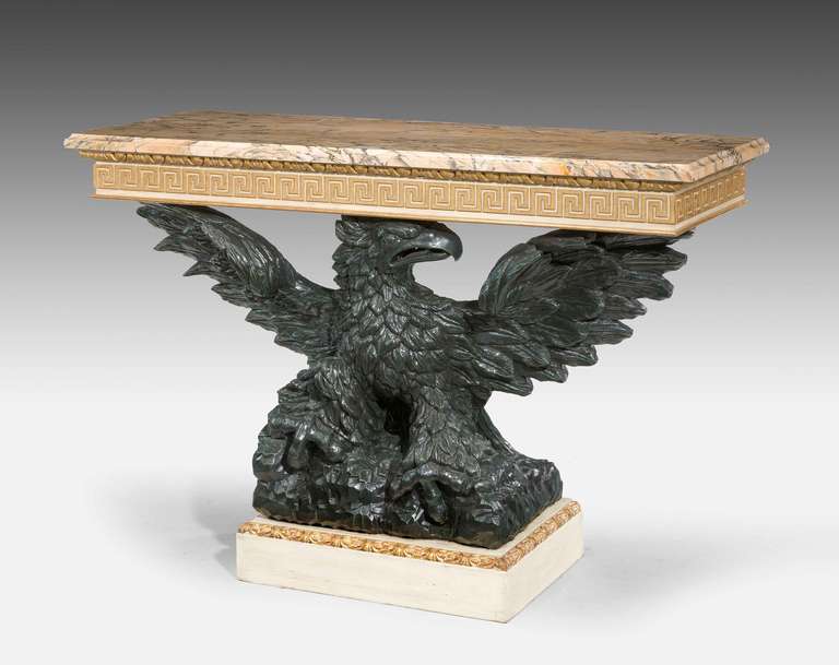 A late 19th century parcel-gilt pier table, the dark bronzed eagle between painted and gilded borders, the upper section with Grecian key design, faux marble top. Redecorated.

