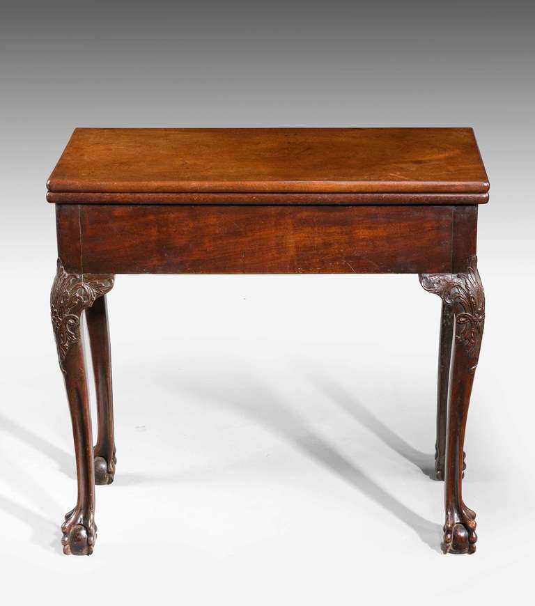 Mid-18th Century mahogany Card Table of very dense West Indian timber. Finely carved knees to cabriole supports terminate in high claw and ball feet, one end incorporating a drawer.

RR