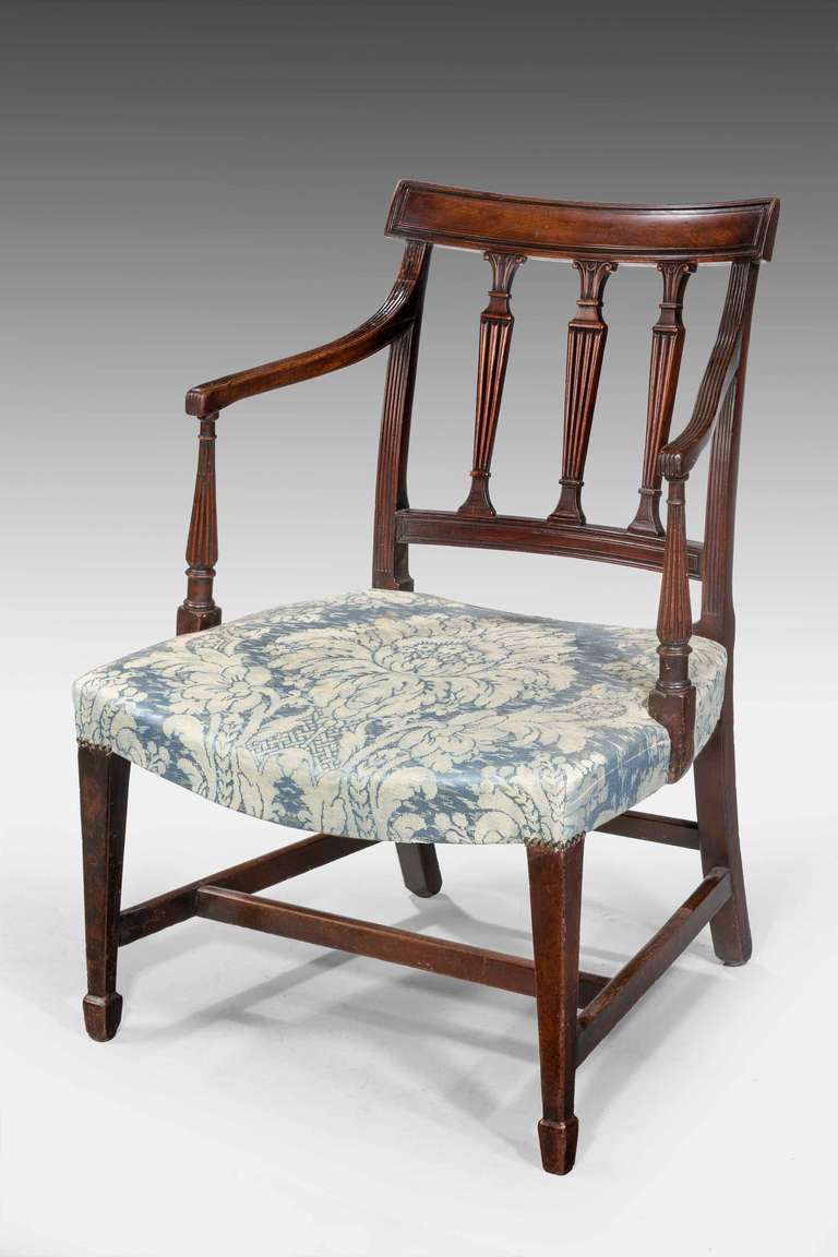 George III period mahogany framed elbow chair, the three upper splats to the back, well carved arms with fine reeding over shaped and turned uprights with block toes.

RR.