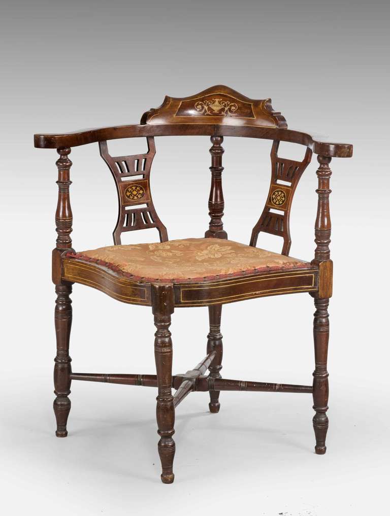 Late 19th Century Victorian period mahogany framed Corner Chair with elaborate boxwood marquetry inlaid with a double serpentine front.