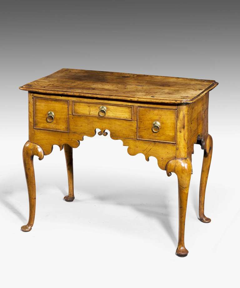 Charming mid-18th century fruit-wood Lowboy, of exceptional line with shaped front over well-formed cabriole supports. A most wonderful color and patina.

RR.