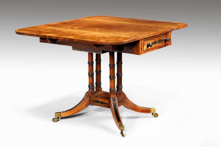 Fine Regency period rosewood Pembroke Table of quite exceptional colour and patina with broad contrasting cross banding and inset ebony sections with line inlay on four well-turned supports.