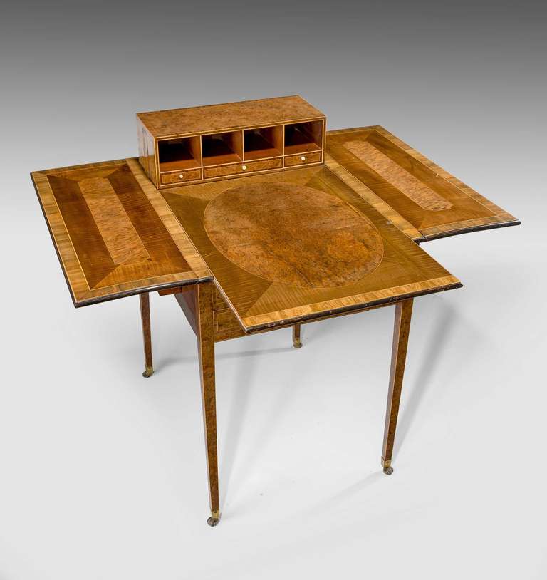 An exceptionally fine Metamorphic Pembroke table of satinwood, burr wood and boxwood inlay. The whole of quite exceptional quality ascribed to Mayhew and Ince, who frequently used yew tree inlay on their finest furniture.

   
