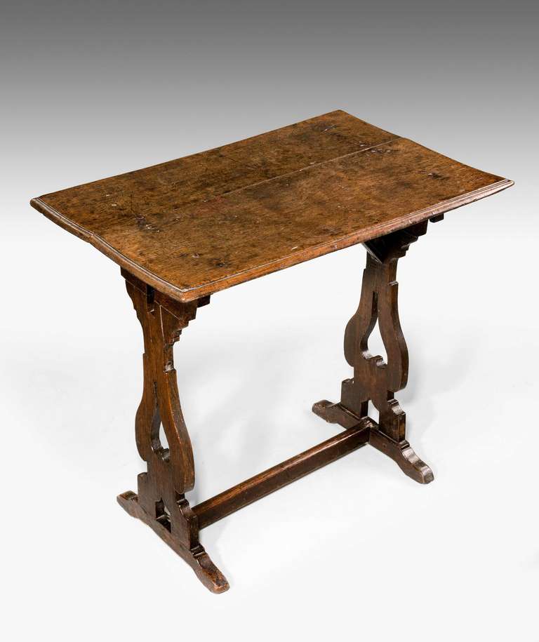 Late 17th Century End Table, the well patinated top with lyre shaped end supports.

