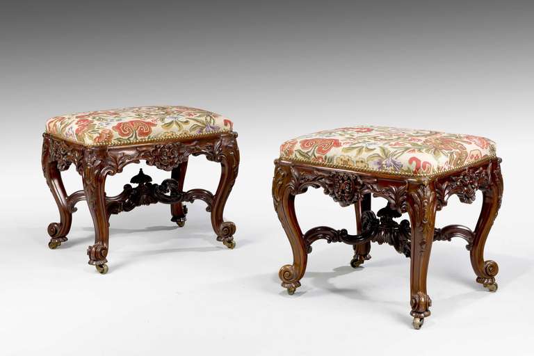 An exceptional pair of mahogany framed stools of the highest calibre standing on French scroll feet. With strong overall French influence, the pair is similar to some of the taste to Gillows of Lancaster, furniture as provided for Tatton Park