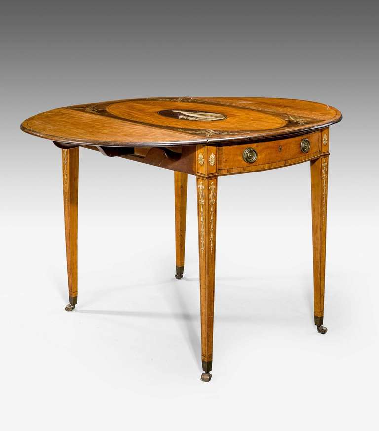 A fine George III period satinwood Pembroke table, the oval top with a central oval finely painted polychrome neoclassical panel within painted borders. The supports similarly decorated.
   