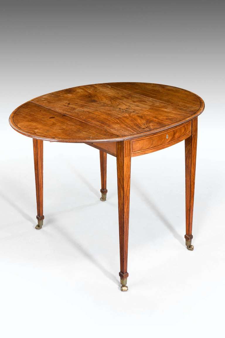 A quite outstanding 18th century Kingwood Pembroke table of extraordinary color and patina. The single drawer with boxwood and ebony line inlay, the fine tapering supports with block toes and elongated original shoes and castors.

