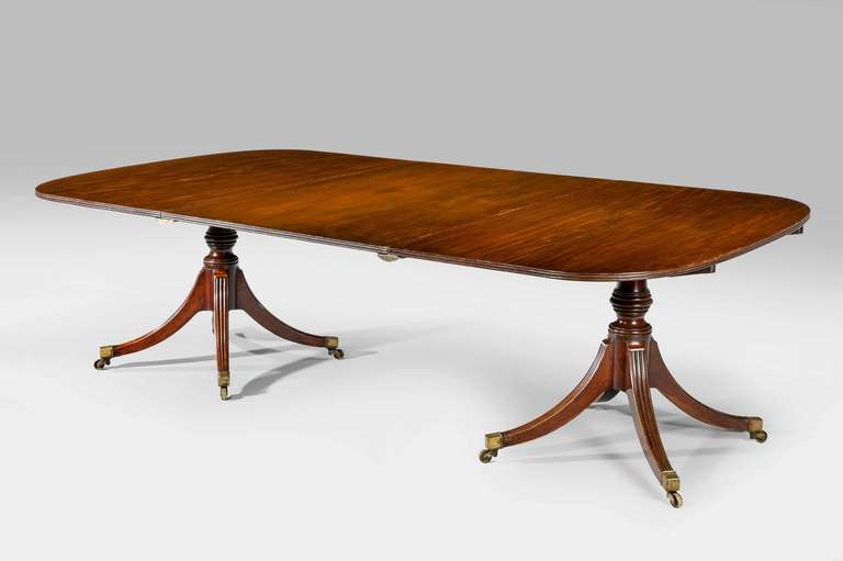 Regency period mahogany two-pillar dining table, the top with a triple reeded edge, well turned 'bee hive' section to the pillars with four swept incised legs.

The price of dining tables, Richard Gillow wrote in 1786, depended on the quality of
