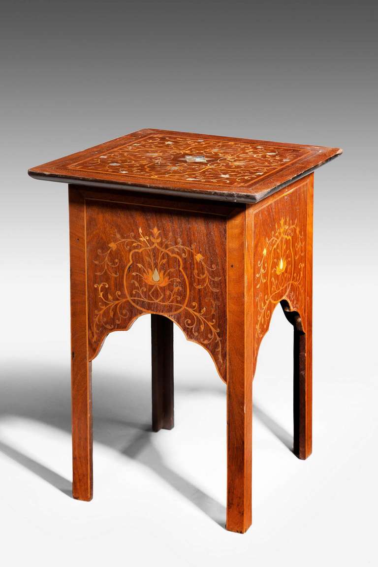 A Middle Eastern Table of rectangular form with very elaborate exotic woods including satinwood, the top of the table with mother of pearl star inlay to the centre with delicate inlaid flowers to the top and the sides.

