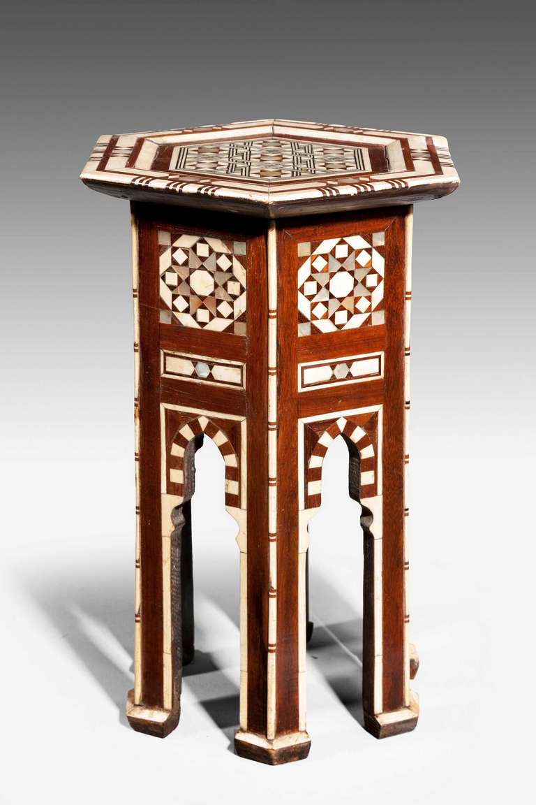 A very pretty hexagon bone and hardwood centre table of small proportions, profusely inlaid with parquetry decoration to the top of the elaborate checked design, central motif in abalone pearl, the legs terminating with block feet.