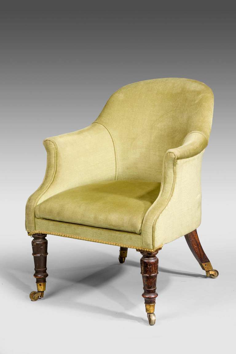 A late Regency period mahogany frame tub chair, the strong turned front supports with lappet sections, retaining original shoes and castors.