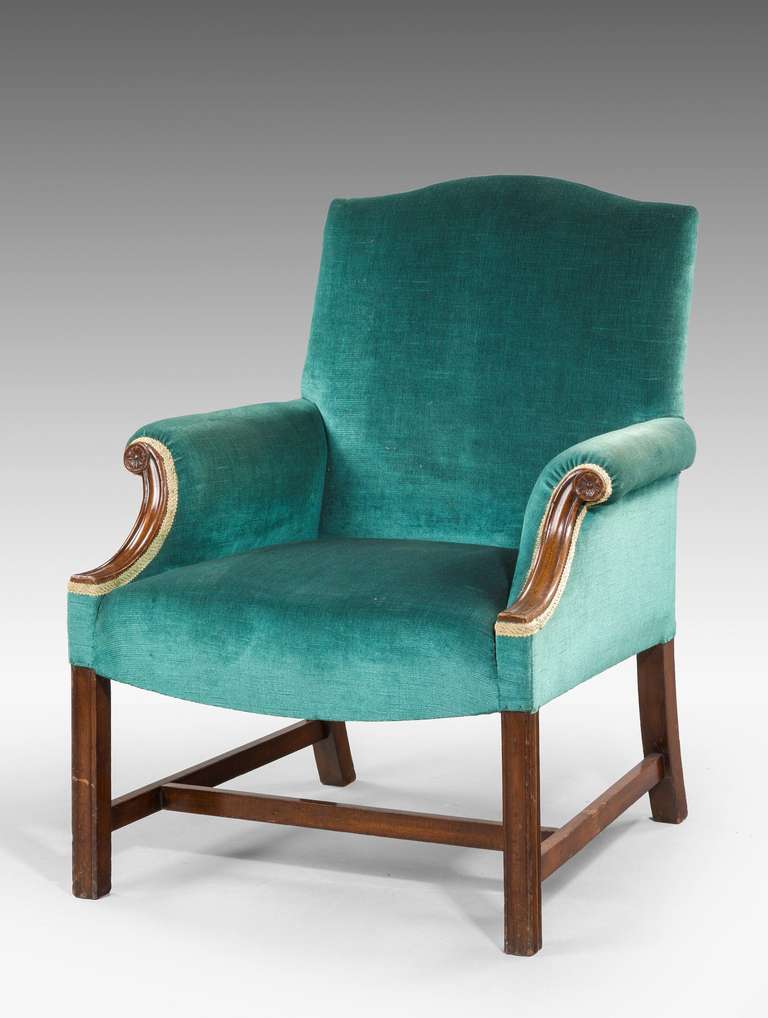An early 20th century mahogany framed Armchair of Chippendale design, the swan neck arm supports with incised decoration, the chamfered supports joined by 'H' stretchers.

RR