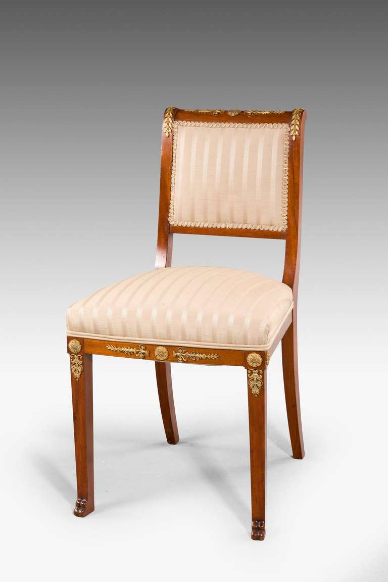 A Set of four mahogany single chairs with gilt bronze mounts. 