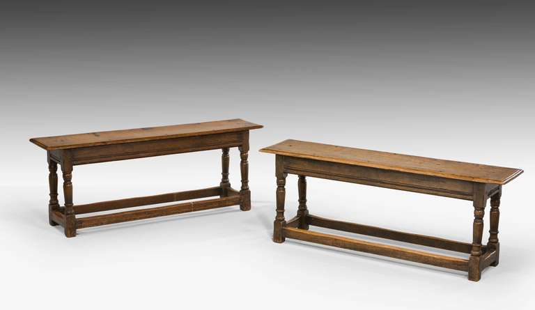 A very good pair of George I oak long stools in excellent overall condition and well-patinated.

