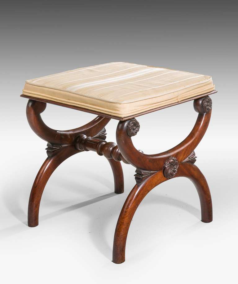 Regency period mahogany stool, the supports of interlocking 'C' sections, joined with a turned stretcher.