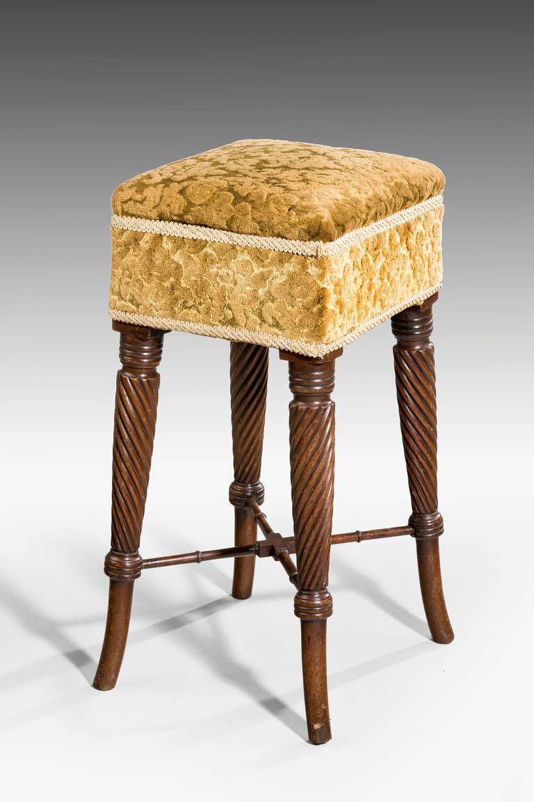 A George III period mahogany Stool with flared writhen supports, joined with a well turned stretcher.

RR