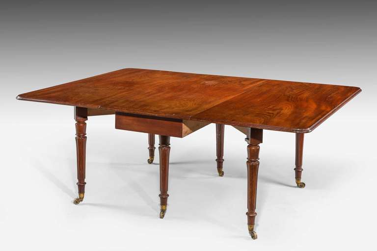 A very good and highly figured Regency period mahogany dining table. Drop leaf, the seating for up to ten persons. Finely reeded turned supports retaining original shoes and castors.

The price of dining tables, Richard Gillow wrote in 1786,