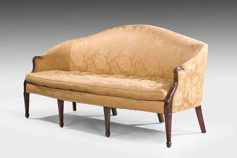 Hepplewhite design mahogany framed Sofa, the shaped front over well carved chamfered supports terminating in block feet.Goose down and goose feathers cushions