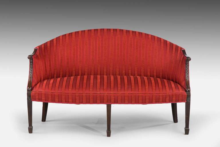An elegant mahogany framed sofa of George III design. The bow front with well shaped supports terminating in block toes. The arms swept, the uprights with harebells.

RR.