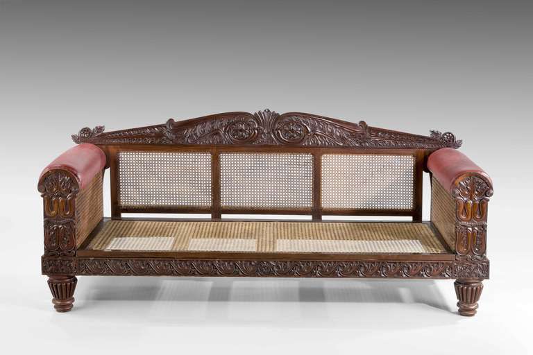 A good mid-19th century Indo-Portuguese sofa with cane and double cane panels, finally carved with stylish foliage, the front rail with a facing of Vitruvian scrolls. Excellent condition.

