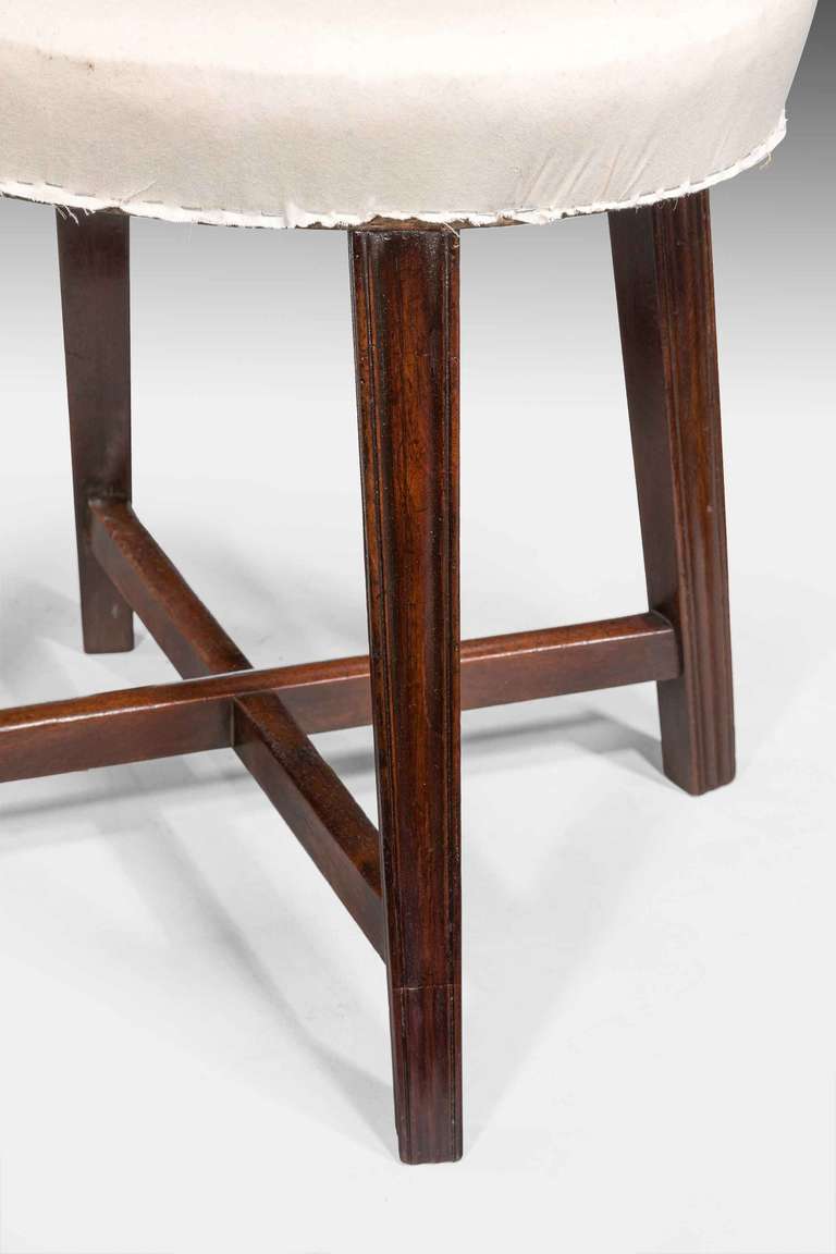 An elegant George III period mahogany oval Stool on finely chamfered and reeded supports, joined with a sturdy cross stretcher. Price to include customer's own material recovered.