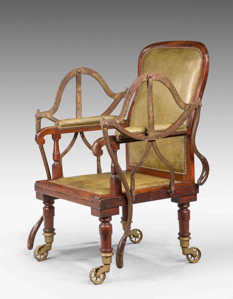 An unusual 19th Century mahogany framed Carrying Chair on original large shoes and castors, the sides with cantilever machinery to allow the chair to be detached from the base and carried.Brass Plaque J ALDERMAN INVENTOR. PATENTEE AND