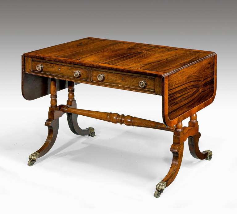 An exceptionally well figured Regency sofa table, crossbanded and with well-turned supports over the swept feet.

RR.