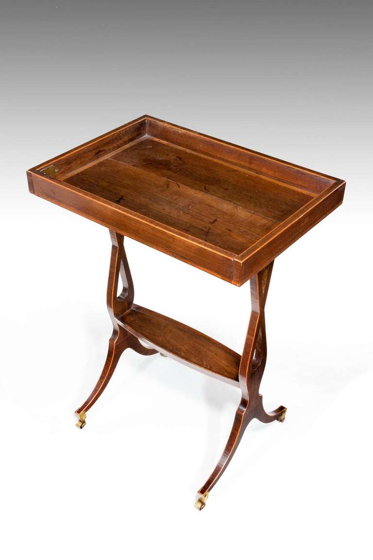 An exceptionally elegant George III period tulipwood vide poche, the top edge cross-banded, the finely drawn supports of unusual slender form with secretaire fall front.

RR.
