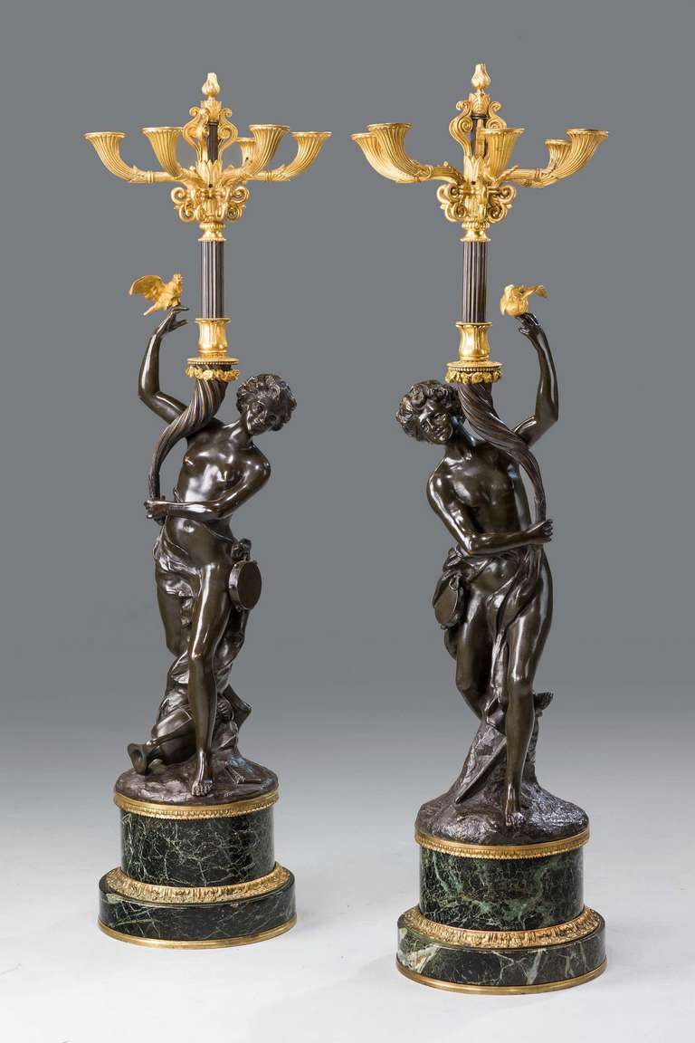 A massive pair of 19th century Italian bronzes, gilt bronze and Verde antico marble neoclassical candelabra, the figures supporting six arms with fluted decoration. After Claude Michel Clodion signed on the bases.

RR.