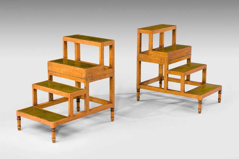 Unusual pair of satin beech library steps or occasional tables with inset tooled green leather surfaces, mid-20th century.

RR.