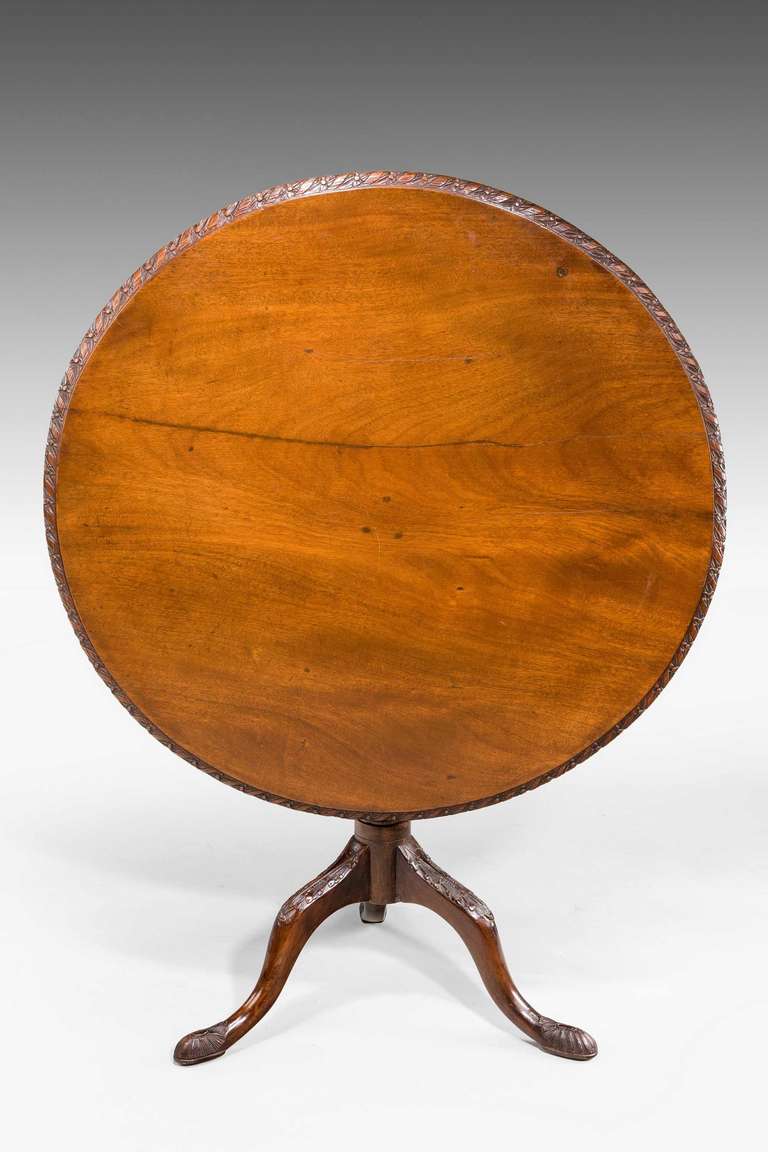 A George III period mahogany tilt table with carved and turned centre support with carved decoration to the top of table, table circa 1775-1780, carving of later date.

RR.