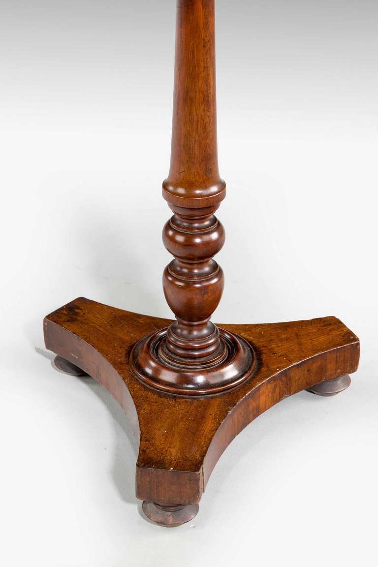 Regency period mahogany tilt table of a small size on a very well turned base, the top with good colour and patination above a tri-form base on original feet.
