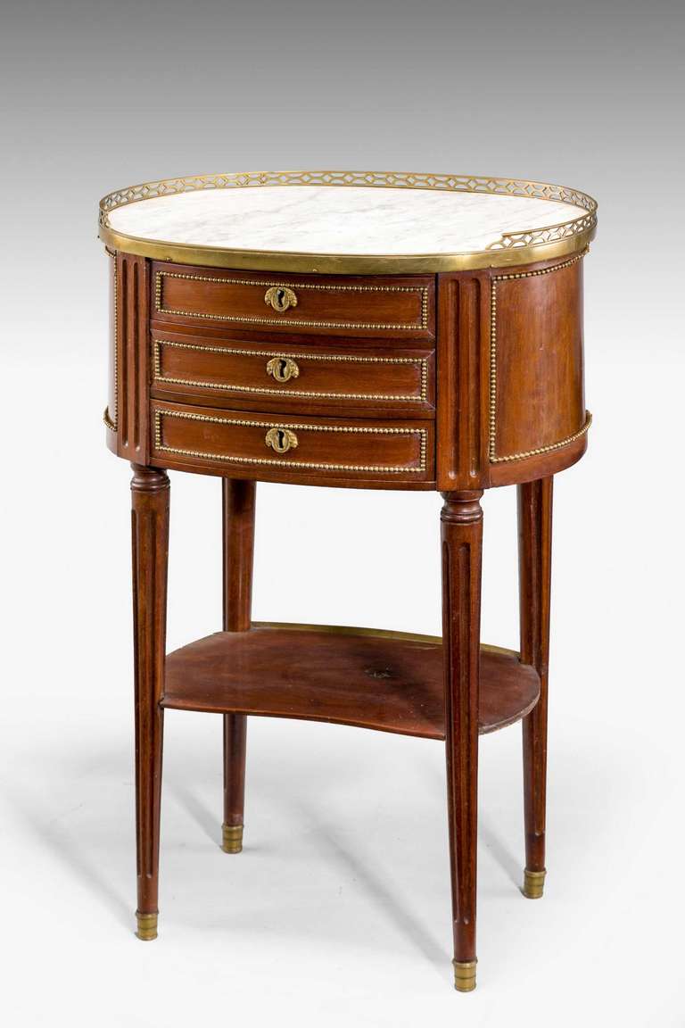 Late 19th century oval mahogany occasional table with inset marble top and gilt bronze beaded decoration.

RR.
