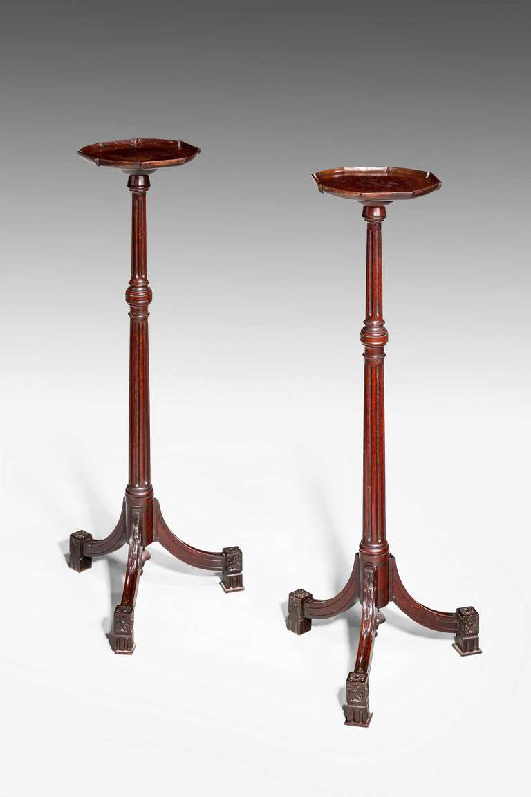 Pair of Regency period mahogany torchère of quite fine line, the reeded centre with knops over flared square section standing on block toes with carved elements, top section shaped and of dish form, good attractive color.

Provenance
Torchères