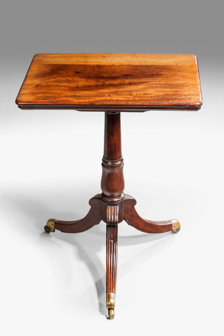 A good George III period mahogany reading and writing table, the rectangular top lifting on an adjustable rachet, the centre stem with a gun barrel section to the middle lowering on to a plumb shaped base, the top of particularly good color, three