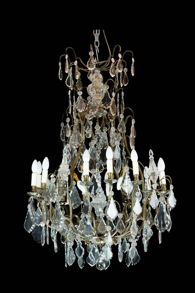 A good French gilt bronze and crystal chandelier, the frame of square section gilt metal with a multitude of lozenge cut drops and a small moulded sunburst top.

